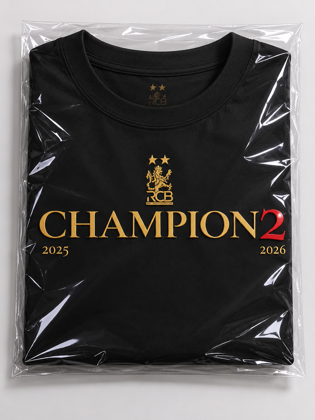 Black t-shirt with gold 'Champion 2' logo in packaging on a white background. RCB Champions Tshirt from Nitorious Atelier 