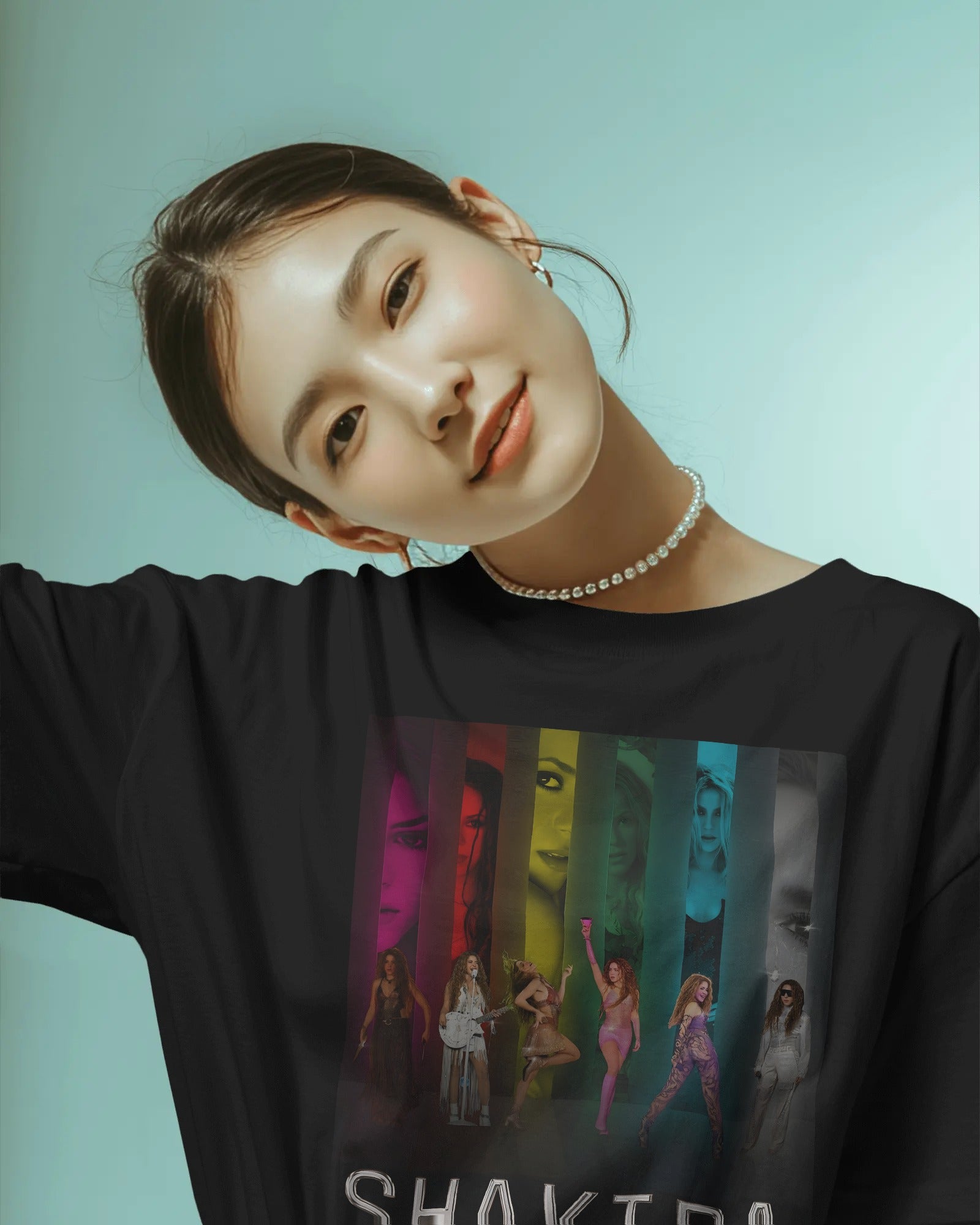 Person wearing a black long-sleeve shirt with colorful graphic design on a light blue background