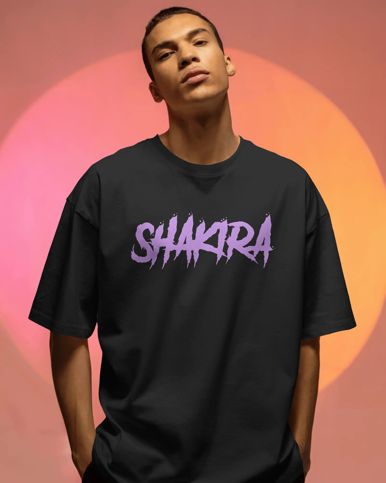 Person wearing a black t-shirt with 'SHAKRA' in purple on a gradient background