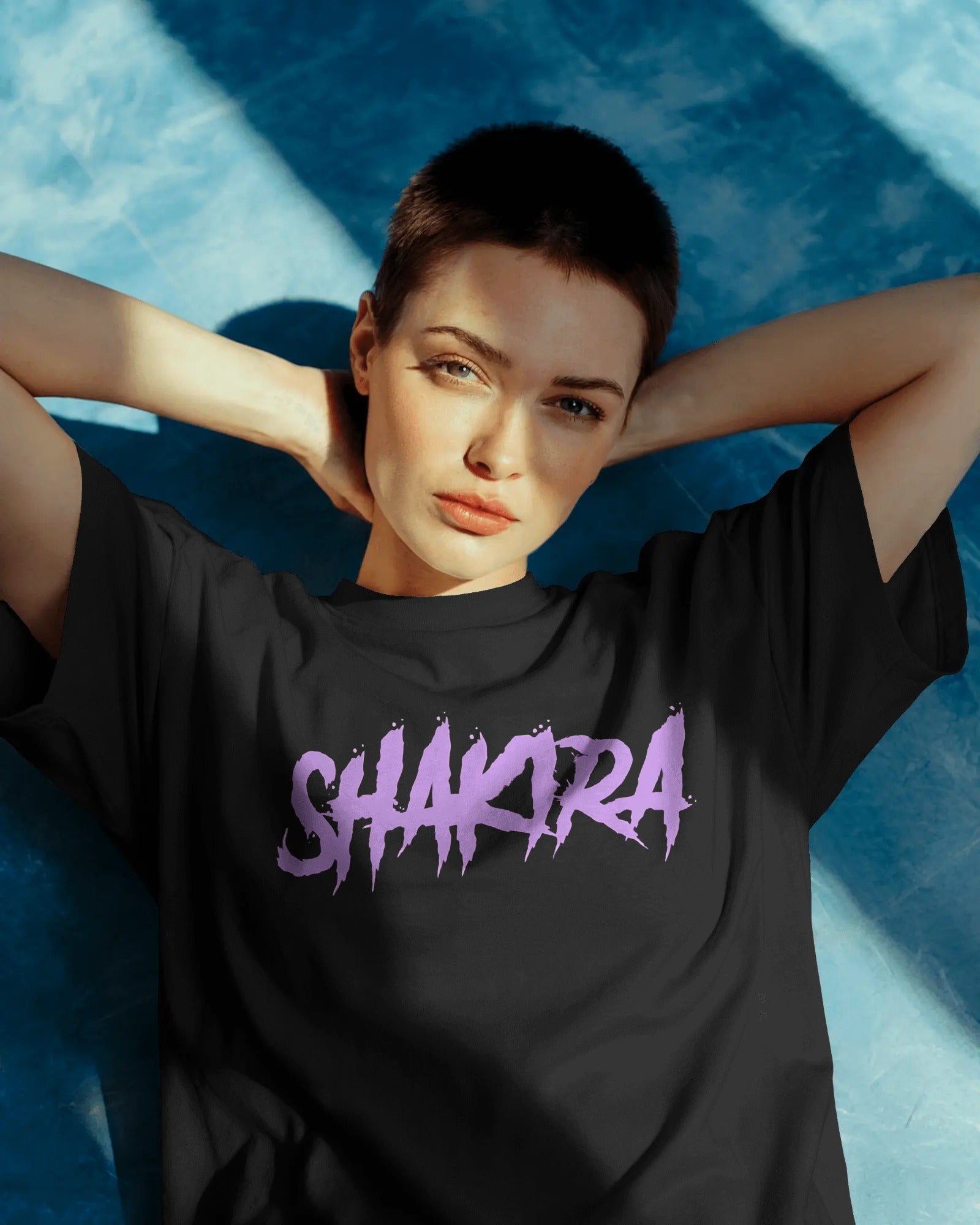Oversized black graphic tee featuring Shakira concert logo design