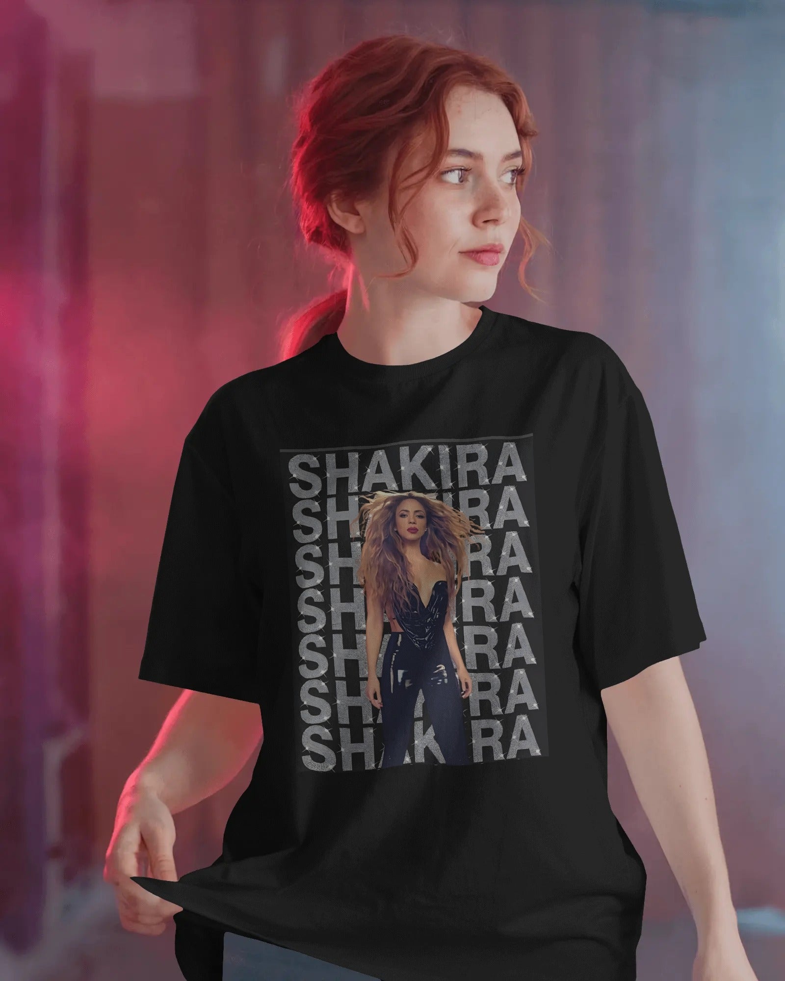 Person wearing a black t-shirt with Shakira graphic and text