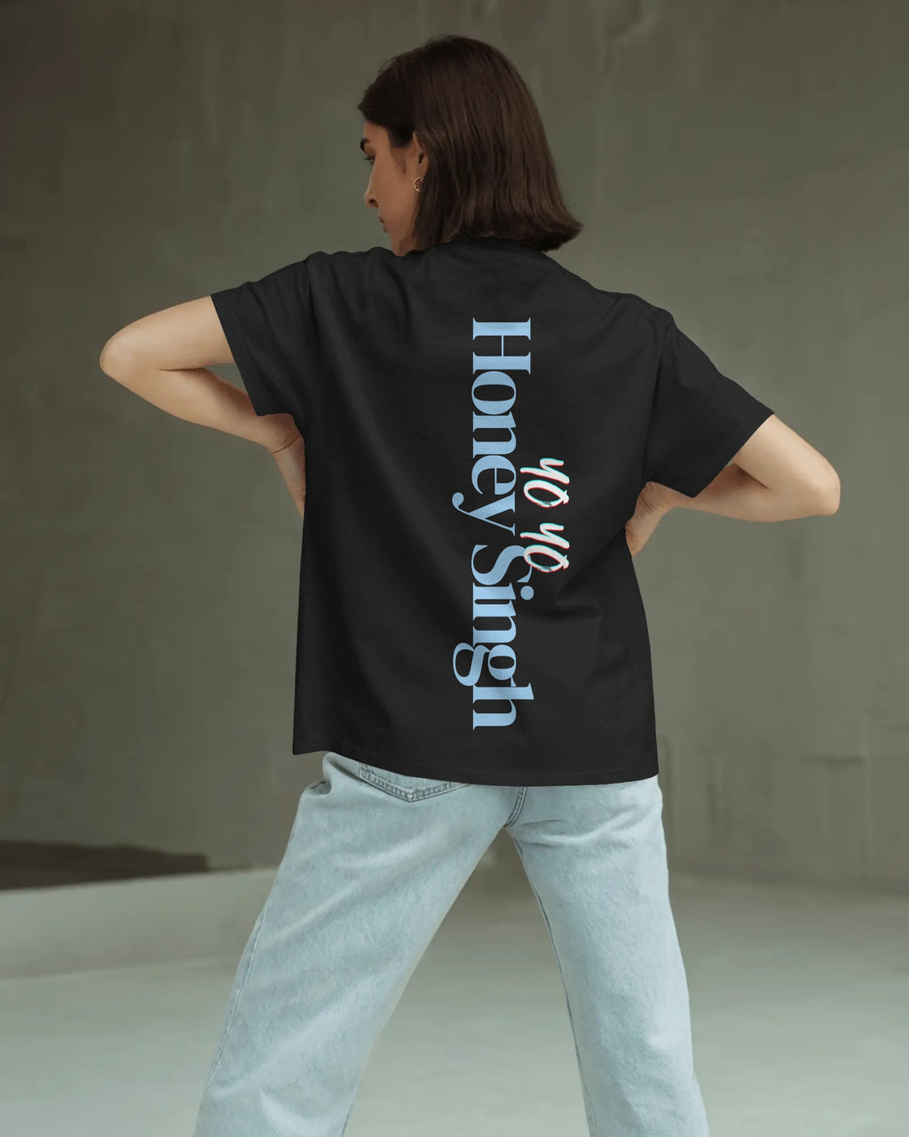 Person wearing a black t-shirt with 'Honey Singh' branding on the back, standing against a neutral background.