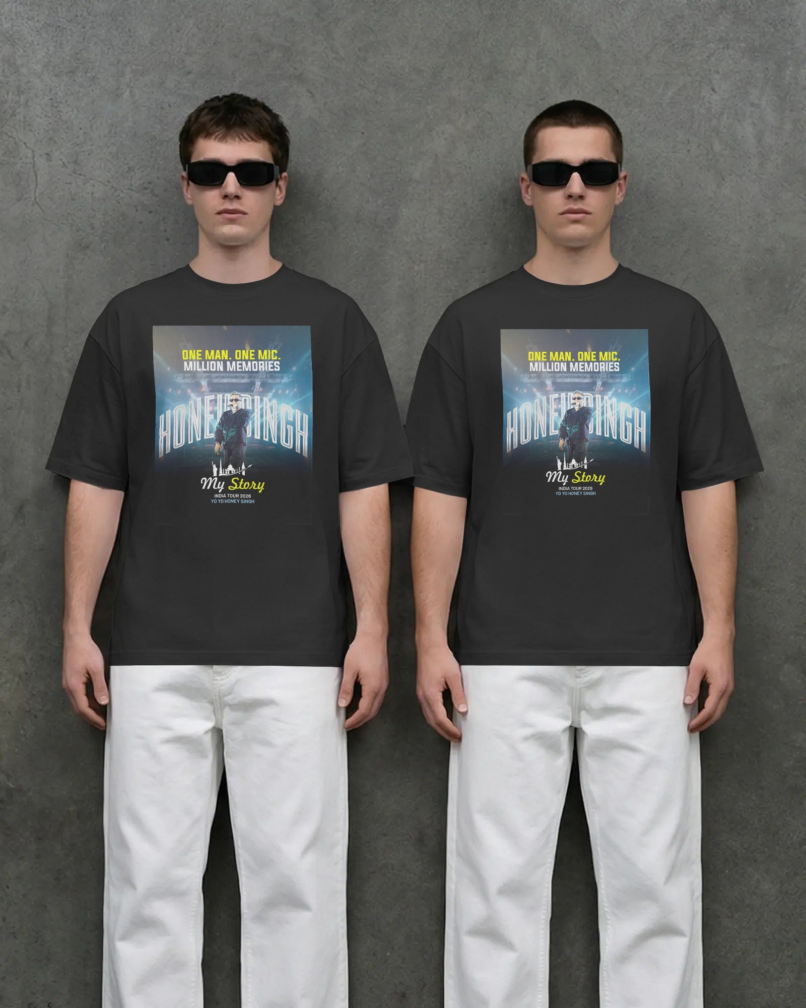 Two men wearing black t-shirts with a graphic design on a gray background