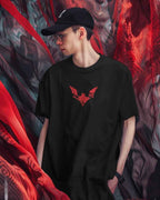 Person wearing a black t-shirt with a red logo against a colorful abstract background